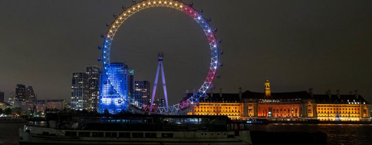 A view of the London Eye at night lit in the Union jack colours and the Ukraine flag colours