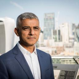 Mayor of London Sadiq Khan posing for picture with City of London in the background