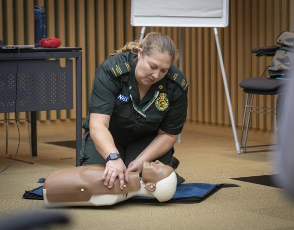 A health worker running a CPR training session