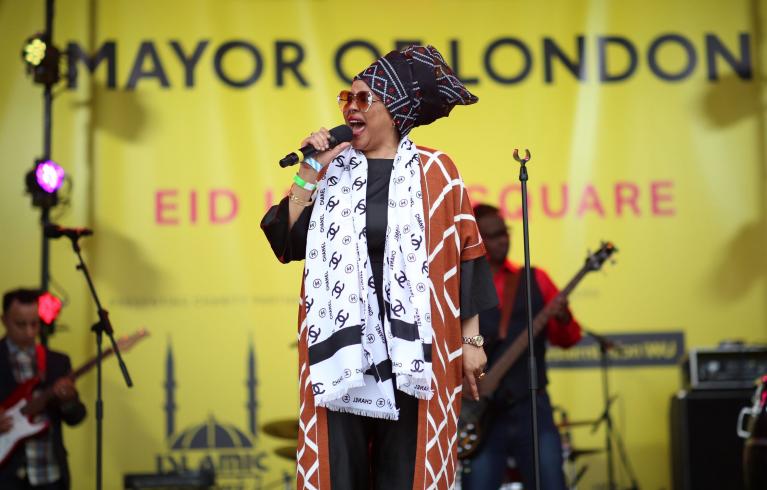A performer on stage at Trafalgar Square during Eid in the Square