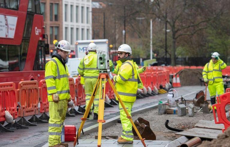 Roadworks in progress with four people in hi-vis clothing