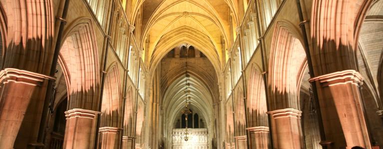 Inside Southwark Cathedral from the back with views of vaulted arches during the service