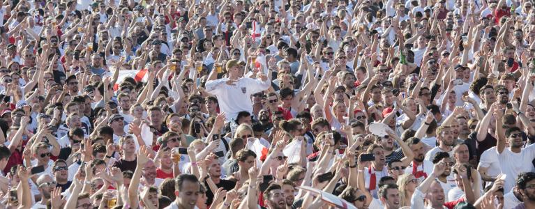 Crowds of fans with England shirts on at a football match