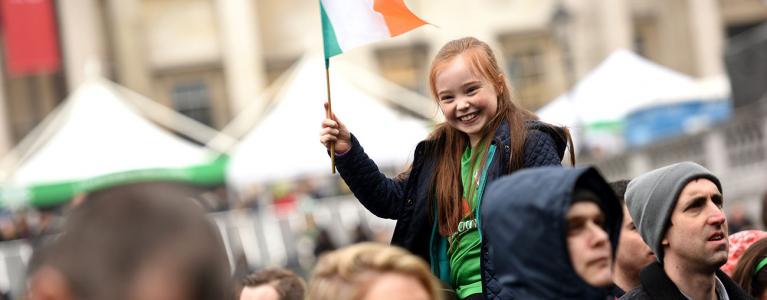 Girl holding the Irish flag on St Patrick's Day in Trafalgar Square