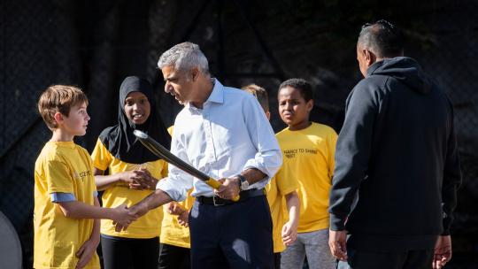 Sadiq Khan shaking hands with a child at Shine Street Cricket event
