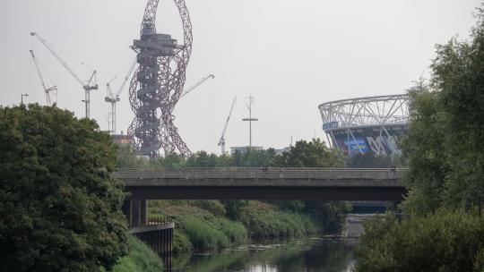 Hazy view across the canal towards the orbital and london stadium in stratford