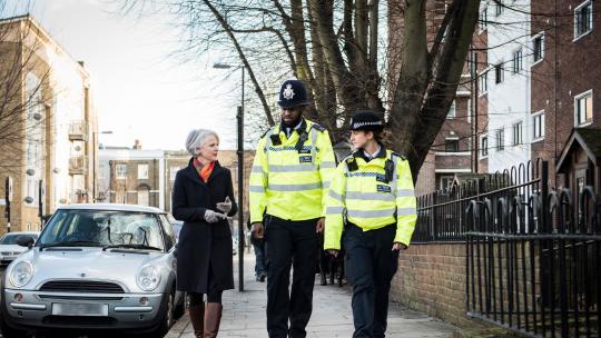 Sophie Linden walking with two police officers
