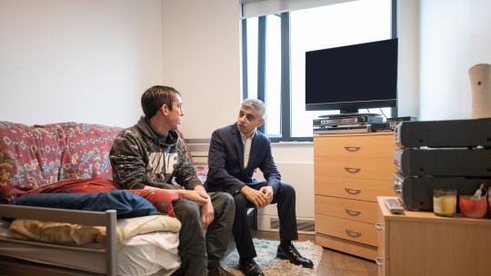 Mayor of London, Sadiq Khan chats with homeless person sleeping in hostel