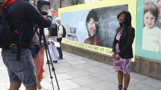Deputy Mayor for Communities Debbie Weekes-Bernard is being filmed in front of huge mural featuring Dr Beryl Gilroy