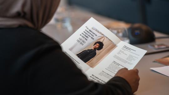 Attendee reading FGM round table event programme