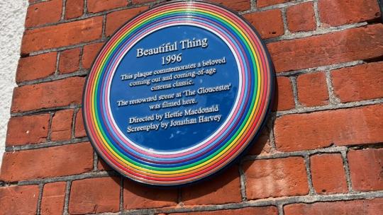A rainbow plaque on a wall in London 