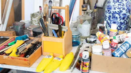 Table full of paint and art materials at Gnome House community arts centre Walthamstow