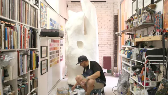 Man working on sculpture