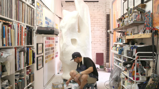 Man working on sculpture