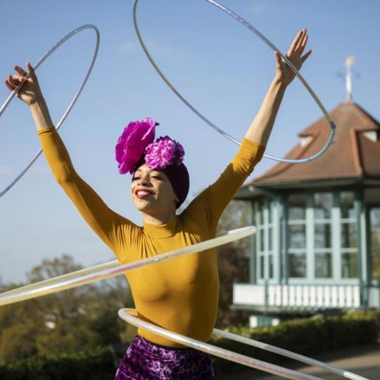 A person hula hooping with four hula hoops