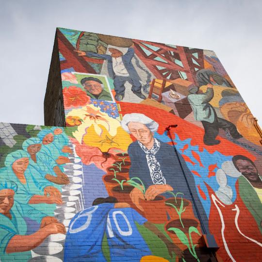 A colourful mural depicting a diversity of people from different generations, cultural and ethnic backgrounds