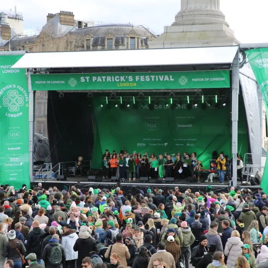 Photo of main stage with a crowd of people in front of it.