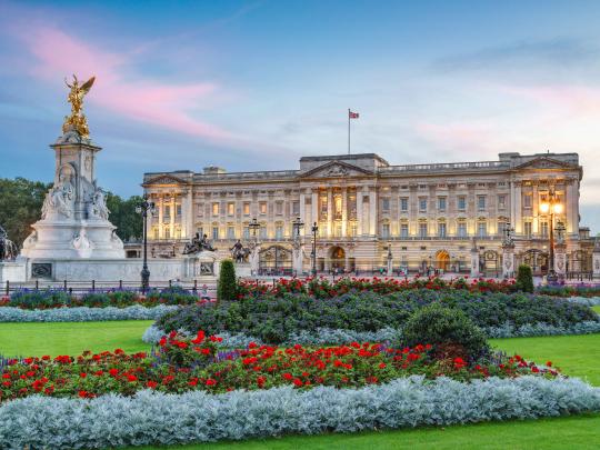 Rose garden and Queen Victoria Memorial in front of Buckingham Palace at sunset