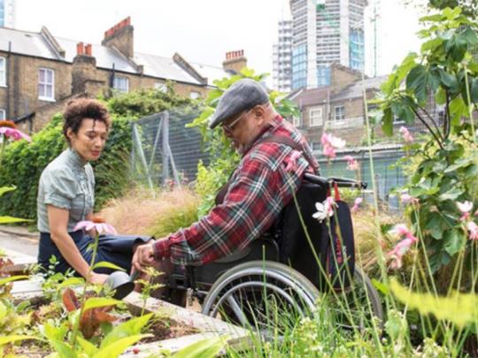 Two people gardening in a community space