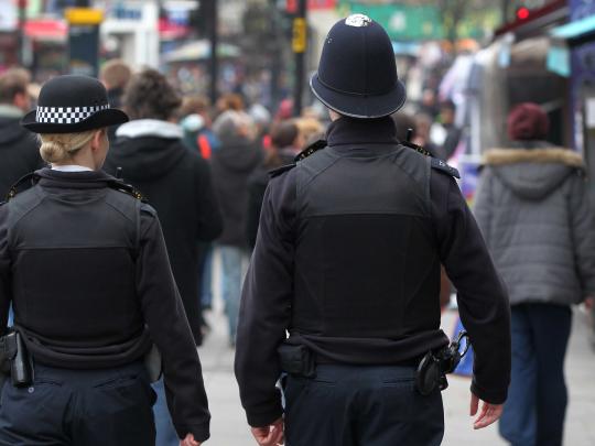 Two police constable patrol a high street
