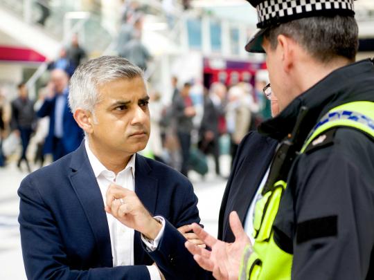 Mayor of London Sadiq Khan speaks with a police officer at Liverpool Street station