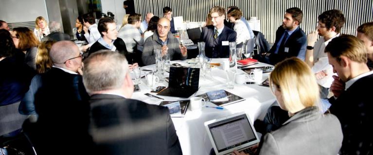 People discussing around a table at Smart London event