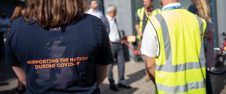Picture of volunteers at Lewisham Donation Hub from the back and showing vests