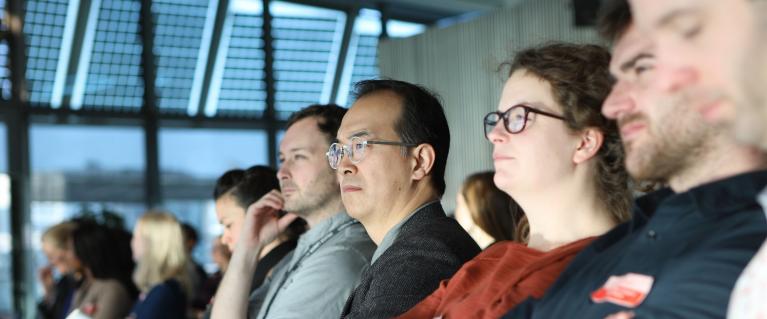 People listening to conference at Social Integration Design Lab Showcase event
