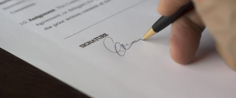 Hand of person signing document