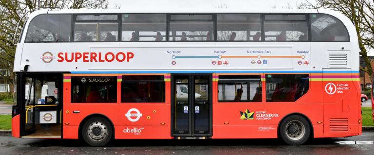 A double decker London bus with the superloop roundel on the side and the word Superloop in large red letters