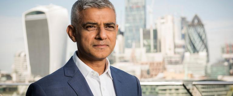 Mayor of London Sadiq Khan posing for picture with City of London in the background