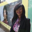 Deputy Mayor for Communities Debbie Weekes-Bernard stands in front of huge mural featuring Dr Beryl Gilroy