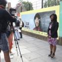 Deputy Mayor for Communities Debbie Weekes-Bernard is being filmed in front of huge mural featuring Dr Beryl Gilroy