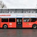 A double decker London bus with the superloop roundel on the side and the word Superloop in large red letters
