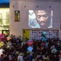 An event outside the Black Cultural Archives with big screen image of Darcus Howe