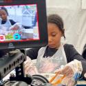 A young girl filming her baking during the Festival of Ideas