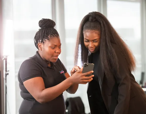 Two young women looking at a mobile phone