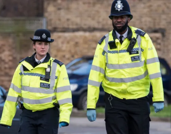 Two police officers walking side by side