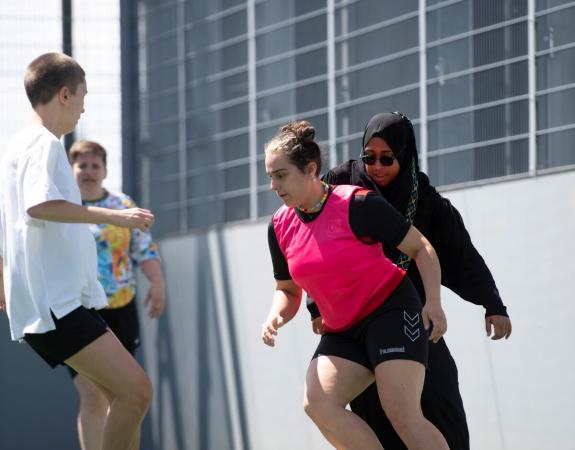 a group of young women playing football and competinh