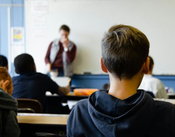 Boy listening to lecture in class