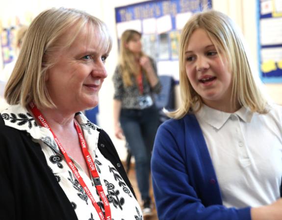 Deputy Mayor for Children and Families speaking to a student