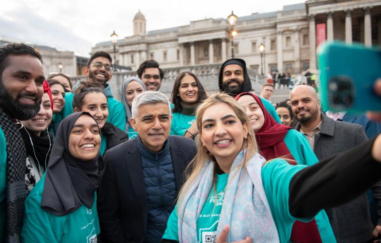 People taking a picture with Sadiq Khan during Iftar celebrations at Trafalgar Square