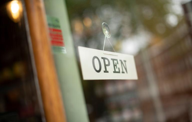 Open for business sign on shop entrance door