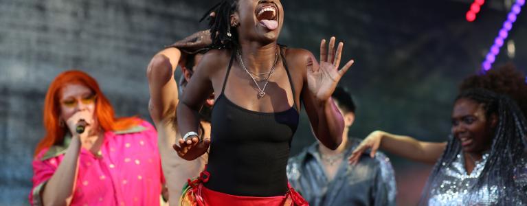 Woman smiling and dancing on stage