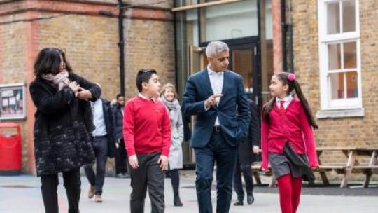 Mayor of London walking with some school children