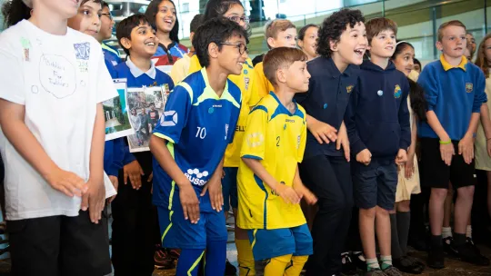Young children standing and cheering