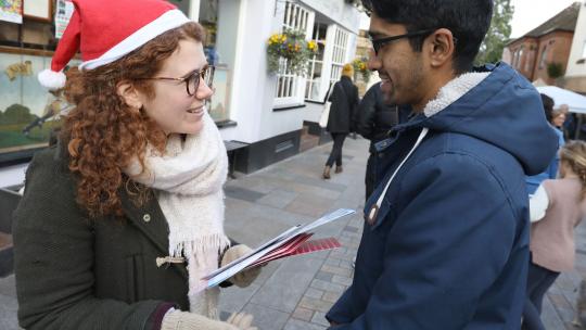 An adviser chatting to a member of the public during an EU Londoners pop up event