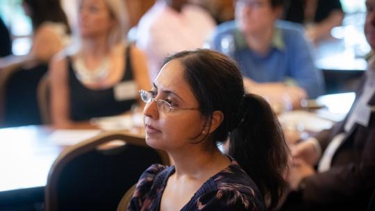 Photo showing a woman listening to a talk at a health summit