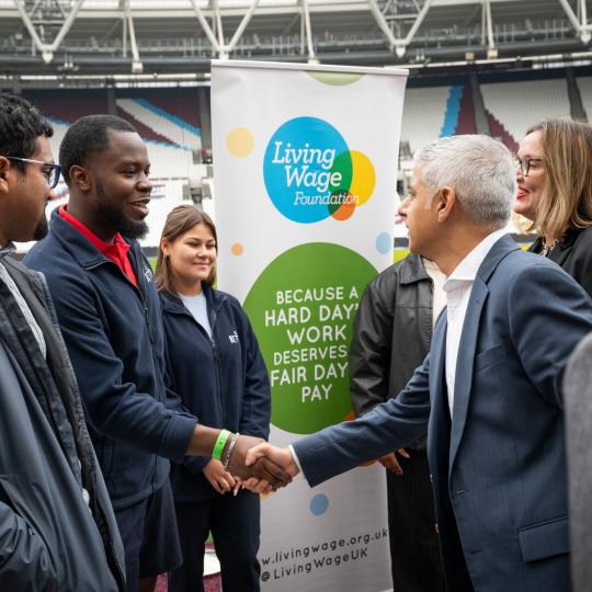 Mayor of London shaking hand with employees at London Living Wage rate announecment 2023, at London Stadium
