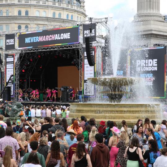 People on Trafalgar square watching large main stage